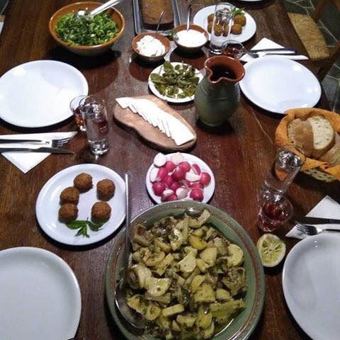 plates from above with various cooked foods like fried meet balls, potatoes with sauce at 'Narlis Farm'